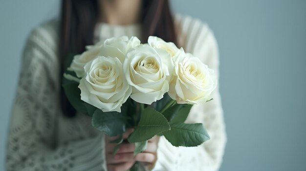 White rose bouquet in the hands of a beautiful girl