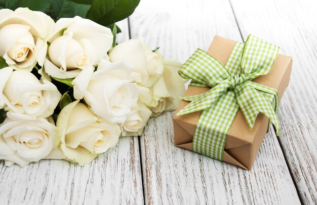 White roses and gift box