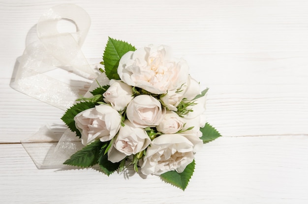 White roses on white table. Top view