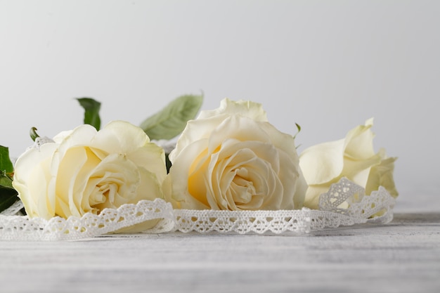 White roses on wooden table