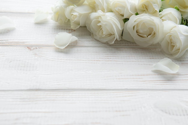 White roses on a wooden table