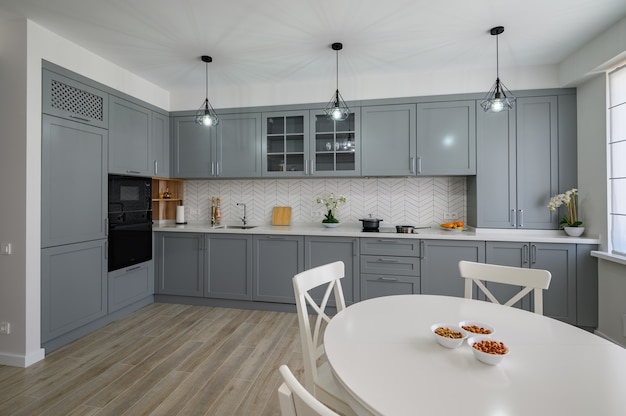 White round dining table and chairs for four at large kitchen