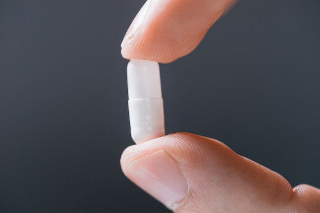 white round tablet in a human hand 