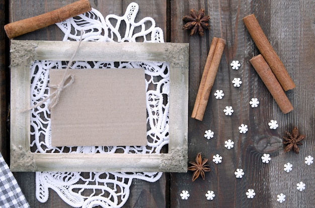 White rustic picture frame on lace with empty carton paper for note