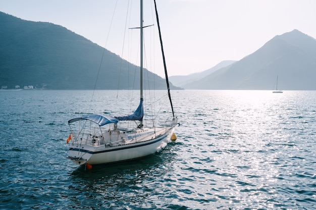 White sailing yacht moored in a bay in Montenegro