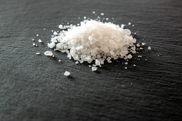 White salt cristals for food on the black background