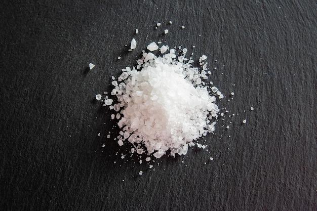 White salt cristals for food on the black background