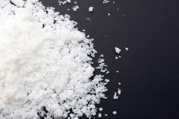 White salt on dark background.