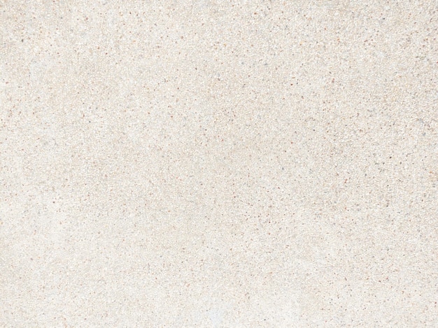 A white sand texture with a black base and a red and white speck on it.