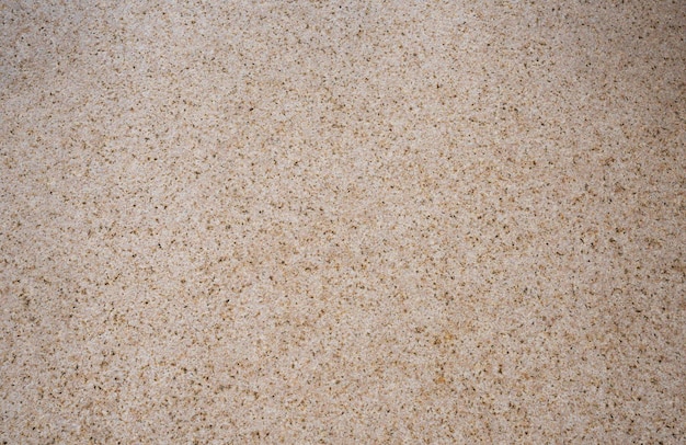 A white sand texture with a brown speckled pattern