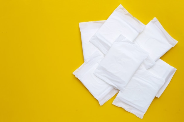 White sanitary pads on yellow surface