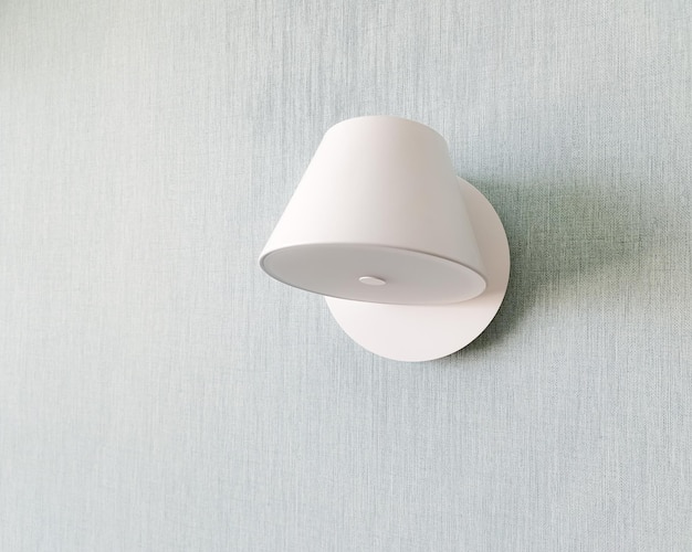 White sconce hangs isolated on wall creative modern wall light source in bedroom lighting in the apartment modern lamp place for text