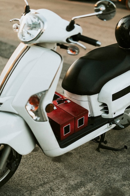 White scooter parked on the sidewalk