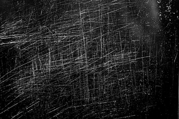 White scratches on a black background. chaotic scratched glass. High quality photo