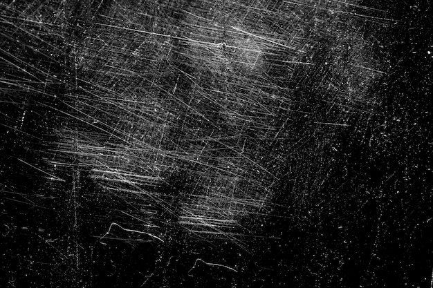 Фото Белые царапины на черном фоне. хаотичное поцарапанное стекло. фото высокого качества