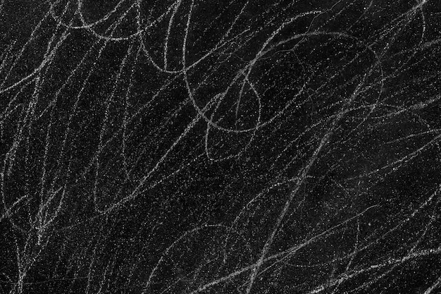 White scratches on rough black concrete wall surface for texture background