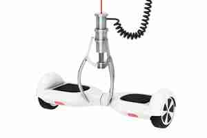 Photo white self balancing electric scooter in a chrome robotic claw on a white background. 3d rendering.