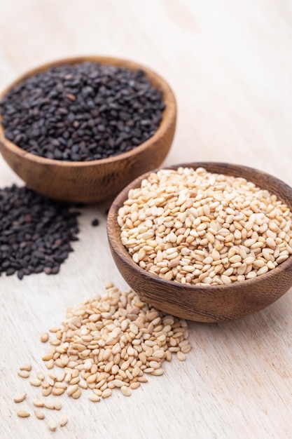 White sesame and black sesame seed on wooden bowl