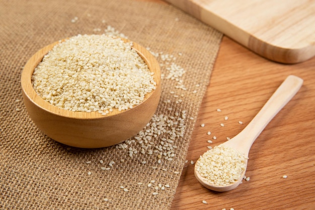 White sesame seeds in wooden spoon and bowlclose up and choose a focus point