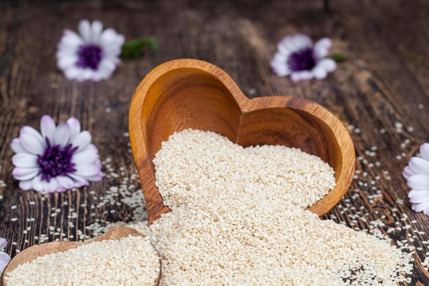 White sesame seeds on a wooden table