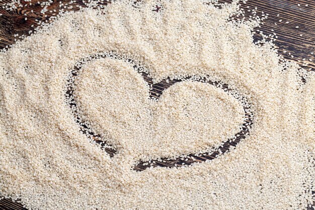 White sesame seeds on a wooden table