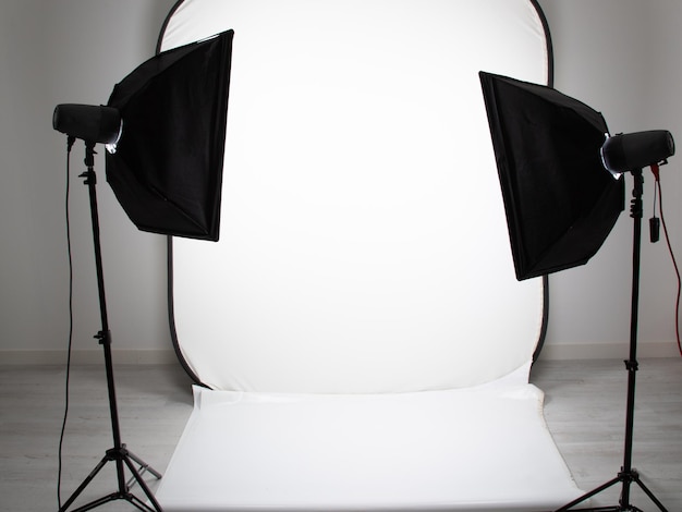 White setup photographer modern photo studio room with professional light equipment