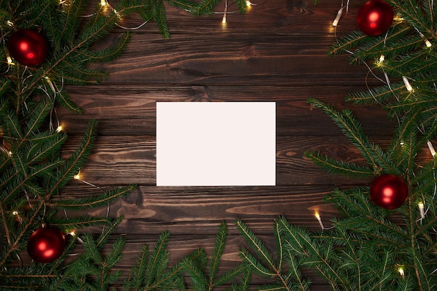 White sheet of paper in a Christmas wreath frame . photo with a place for text.