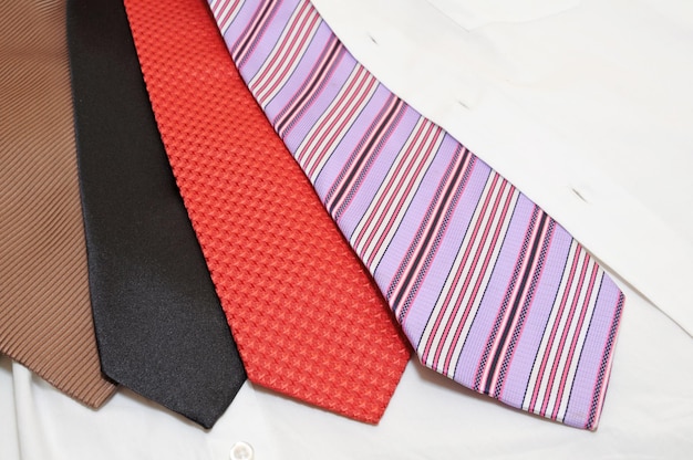 A white shirt with red stripes and a black tie on it