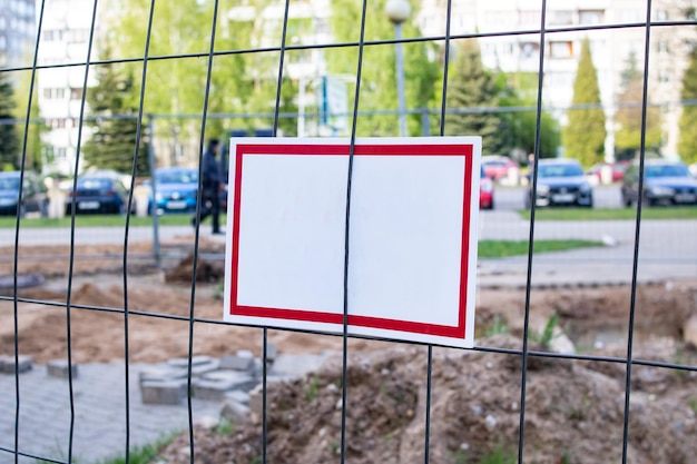 White sign on a fence net close up