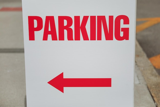 A white sign with a red arrow pointing to the right.