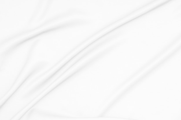 White silk fabric satin cloth surface with soft waves of white fabric texture background