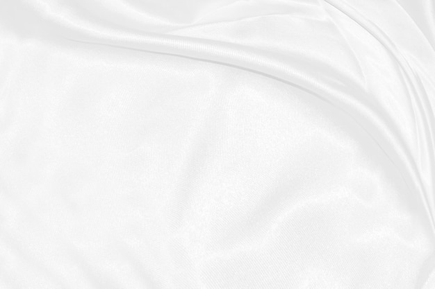 White silk textured cloth backgroundCloseup of rippled satin fabric with soft waves