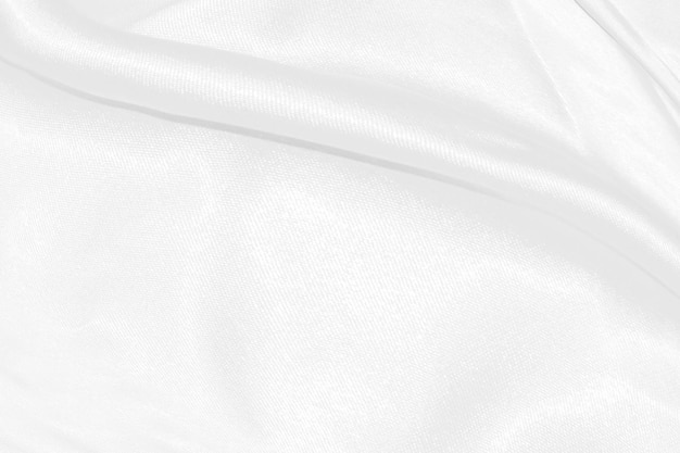 White silk textured cloth backgroundCloseup of rippled satin fabric with soft waves