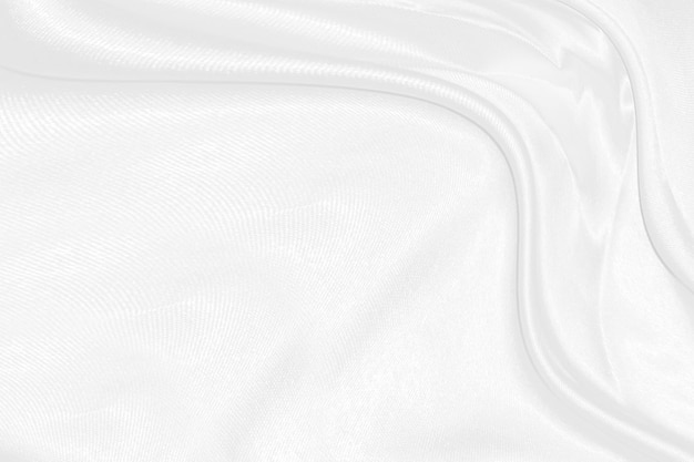 White silk textured cloth backgroundCloseup of rippled satin fabric with soft waves