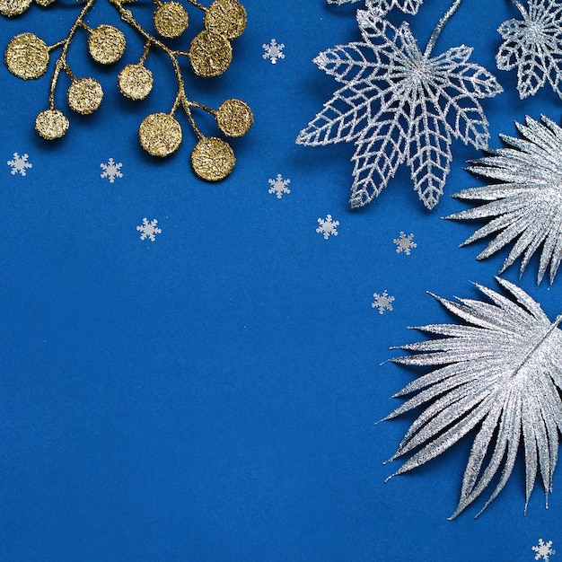 White and silver decorations flat lay on classic blue background with copy space. Christmas background in color classic blue with white and silver ornaments, Christmas background with wish list