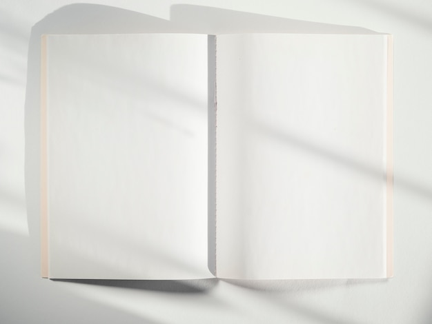 Photo a white sketch book on a white background with shadows