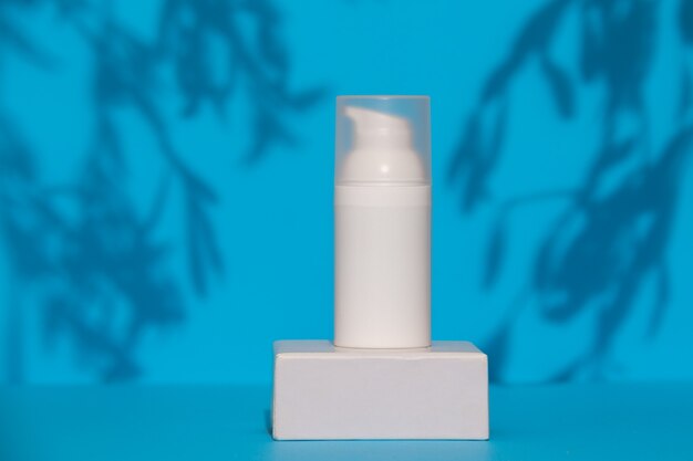 White skincare product tube on a blue background advertisement concept