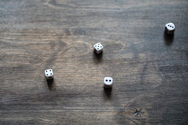 White small dices on a brown wooden texture table