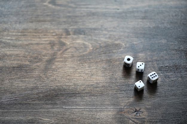 Photo white small dices on a brown wooden texture table
