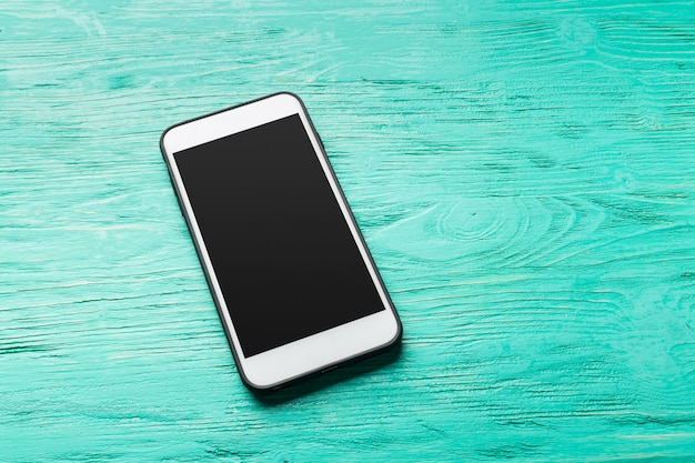 White smart on wooden desk