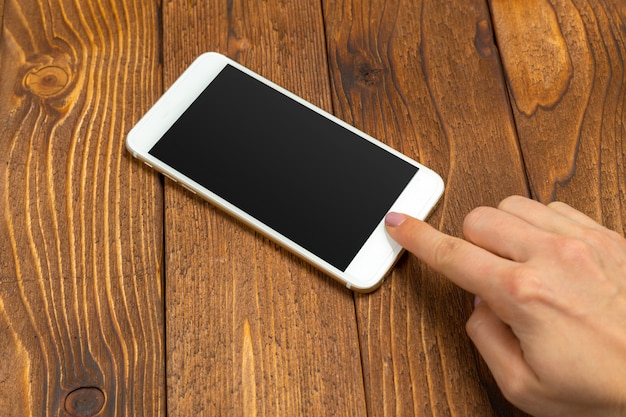 White smart on wooden desk