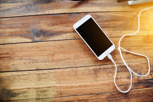 White smartphone on wooden table