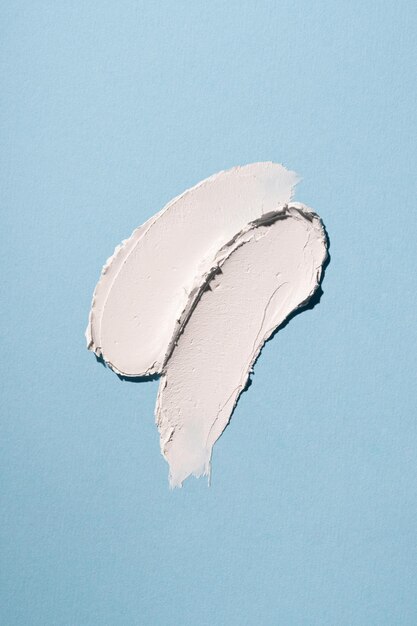 White smear swipe on blue background texture close up macro shot horizontal and verical beauty cream