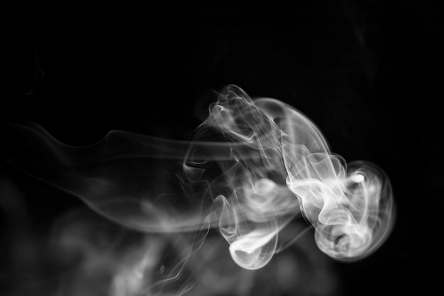 White  smoke motion on black background.