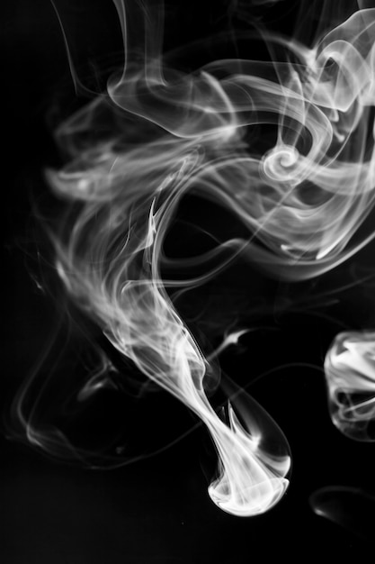 White  smoke motion on black background.