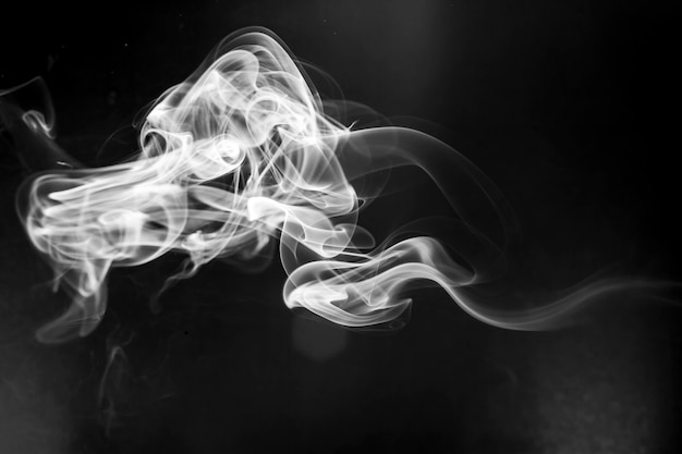 White  smoke motion on black background.