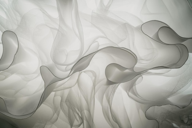 a white smoke swirls in a black background.