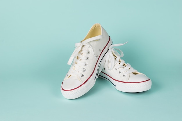 White sneakers made of fabric on a light blue background