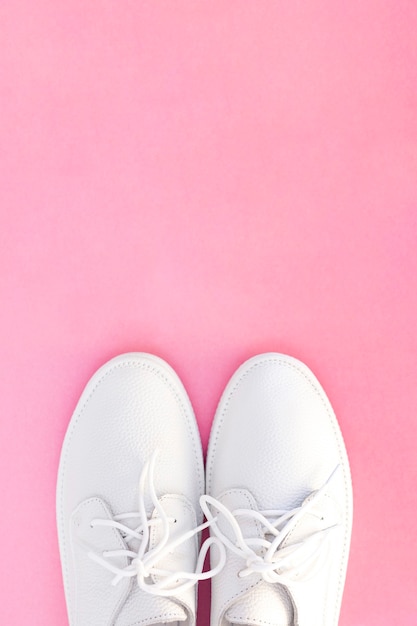 White sneakers on a pink background