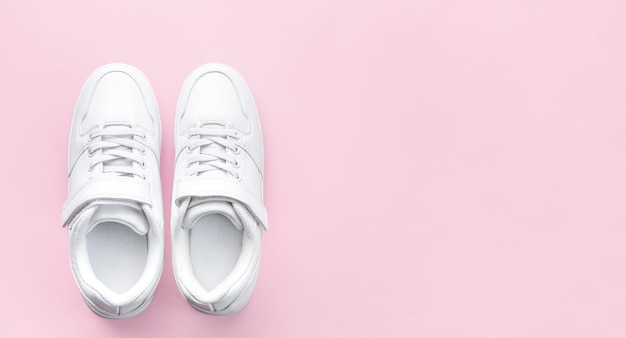 White sneakers on a pink background